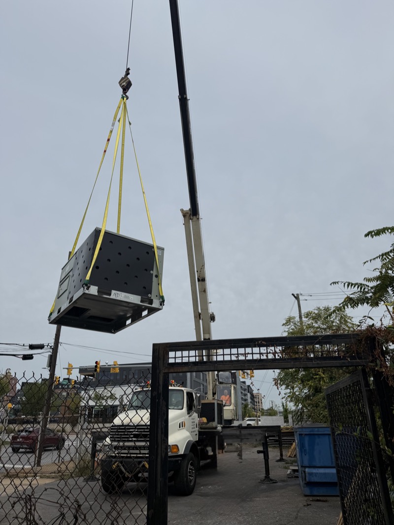 Crane-lifting a rooftop unit into place