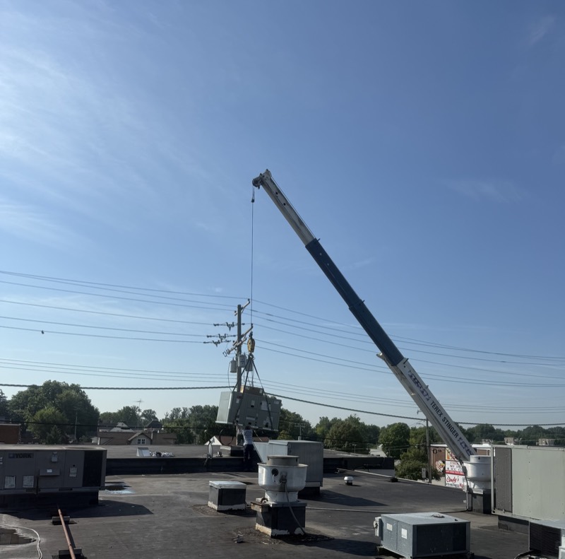 Crane setting equipment on a commercial roof